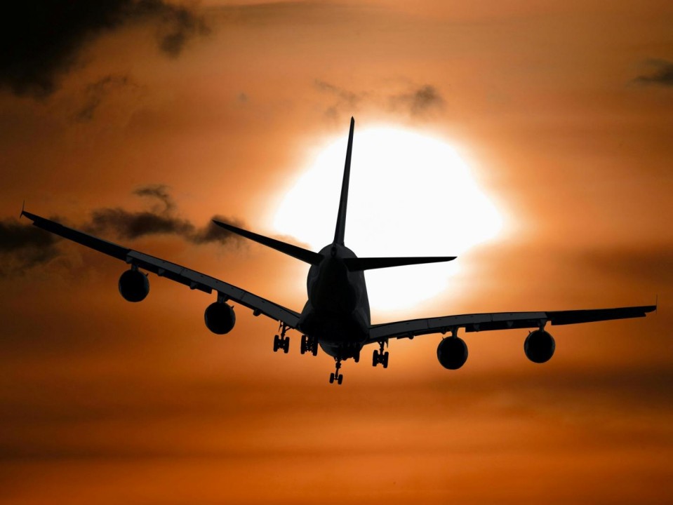 Plane flying during sunset